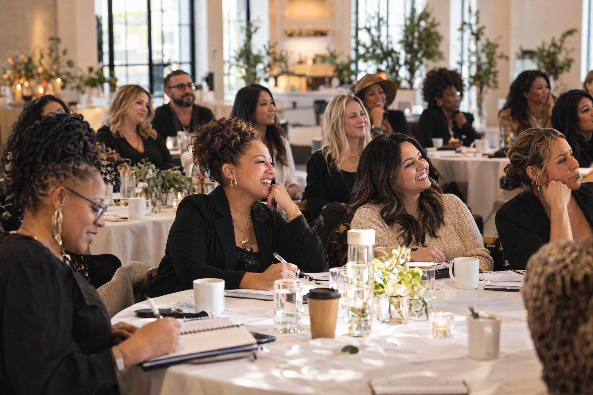 A room of salon owners at a workshop, listening and taking notes. Use real workshop photos if you have them.